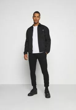 Ellesse GARNA - Pantalon De Survêtement - Black -Ellesse Elegant Boutique 9eeb1a3029e94e0bbf197eb0051bedaf